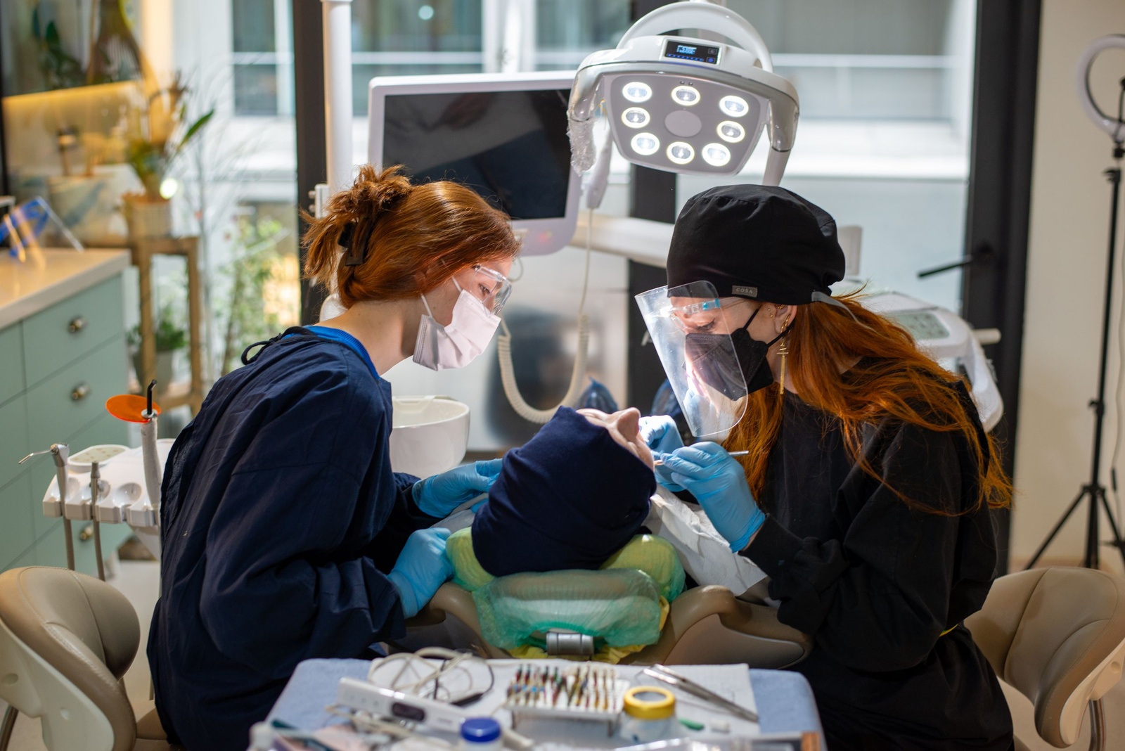 Cadugo dental team caring for a patient in the treatment chair